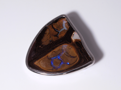 Fine silver ring holding a natural boulder opal from Australia