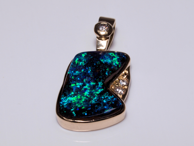 Exquisite solid gold pendant set with a genuine black opal from Australia