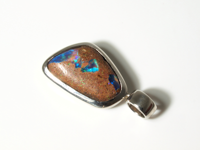 Handcrafted silver pendant with a beautiful blue green boulder opal